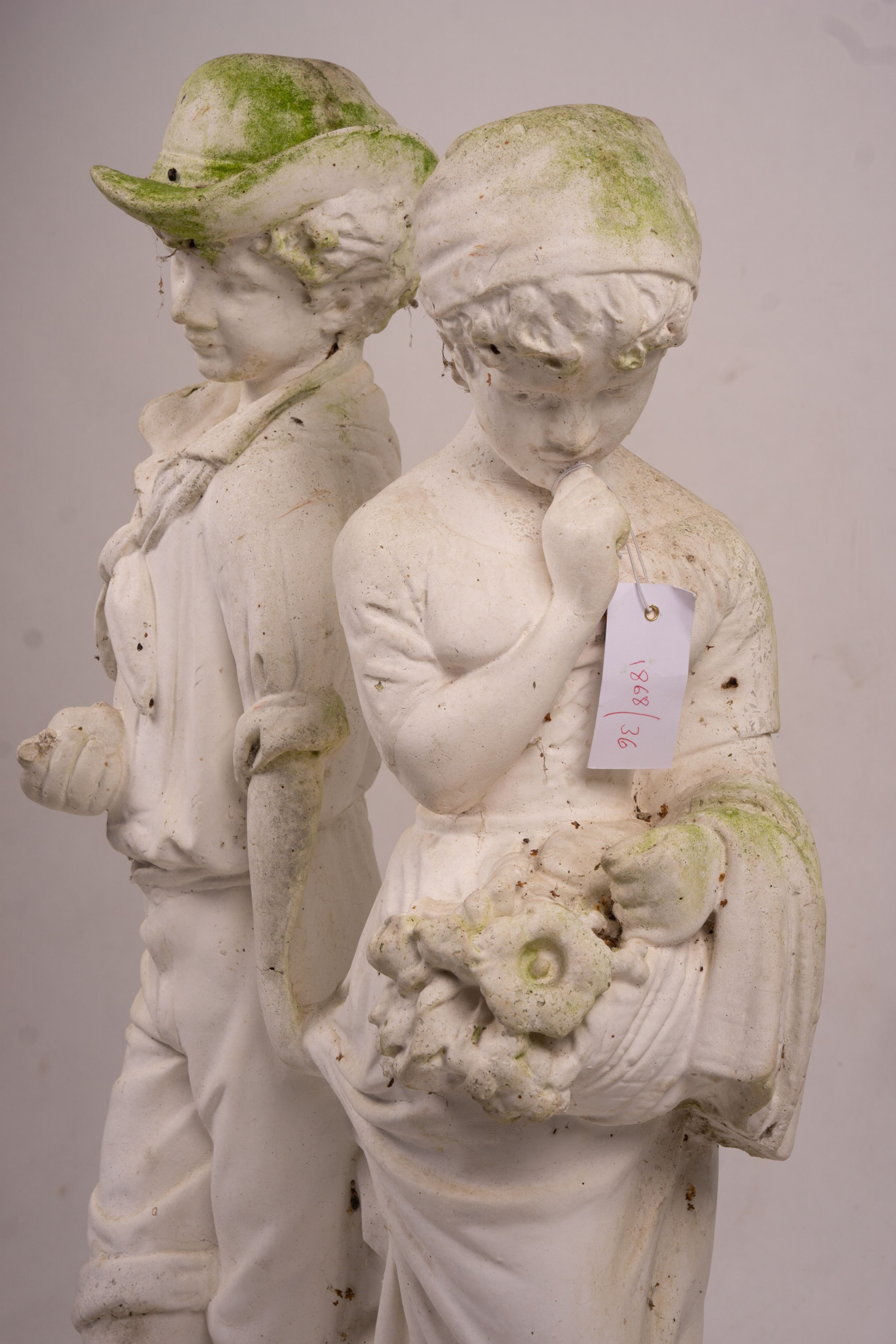 A reconstituted stone garden ornament of fruit and flower pickers, height 89cm